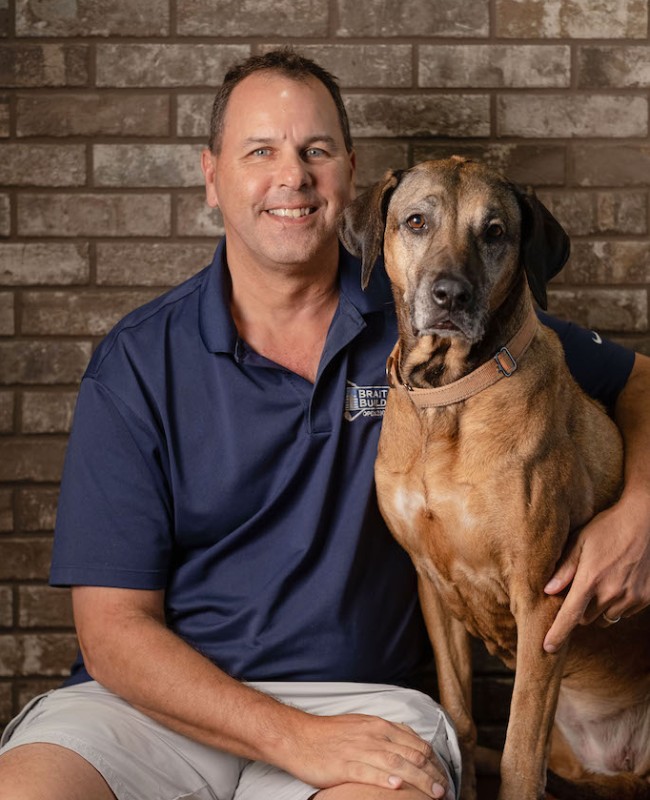 Sean man sitting with pet